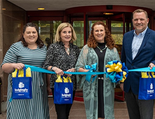 Hospitality House of Tulsa board members and staff celebrate the growth and expansion of Lodgingly, a program offering discounted hotel rooms for patients traveling for medical care. From left: Elise Gaulin, Guest Experience Director; Terri Ramseyer, Advisory Board Member; Toni Moore, President and CEO; and Wes Pebsworth, Board Trustee. Photo courtesy of Hospitality House of Tulsa.