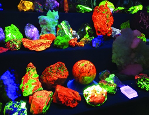 A popular attraction at the show is the society's dark fluorescent room where people can watch rocks and minerals naturally light up from fluorescent light. Photo courtesy of Tulsa Rock and Mineral Society.