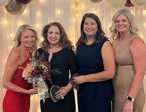 Karen Ogle, in black, was the Leading Lady of the Year for 2022. She is a loan officer for AMC Mortgage.  Photo courtesy of the Claremore Chamber of Commerce.