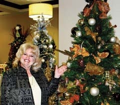 Donna Grabow, executive director of Safenet Services, stands beside one of the many beautifully decorated trees donated to the annual Festival of Trees Gala &amp; Auction to benefit the ­domestic abuse shelter.