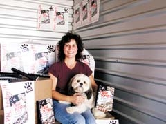 Pet Adoption League volunteer Amy Hoagland has cookbooks ready to sell, and her foster dog, Scarlett, is ready to be adopted into a forever home.